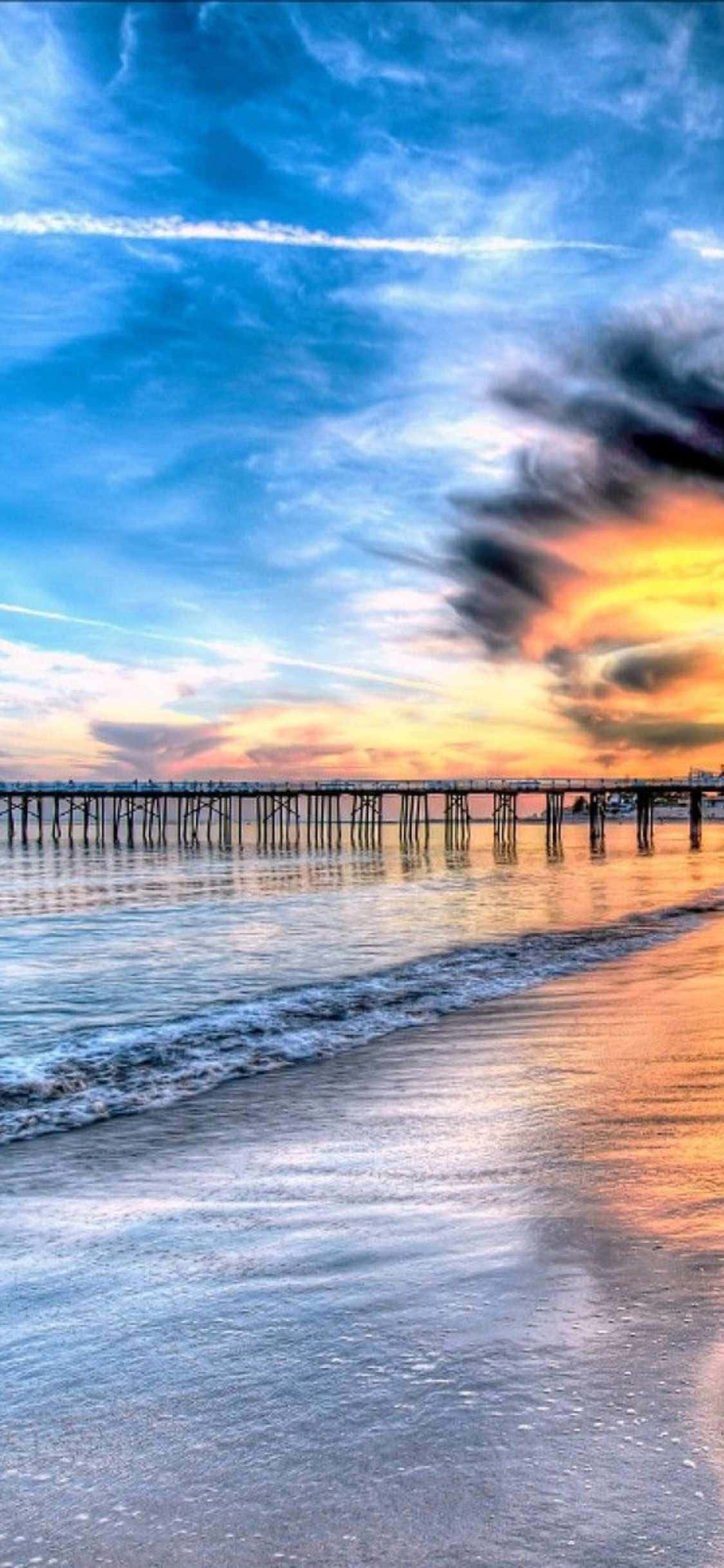 a pier with a sunset over the ocean Ταπετσαρία