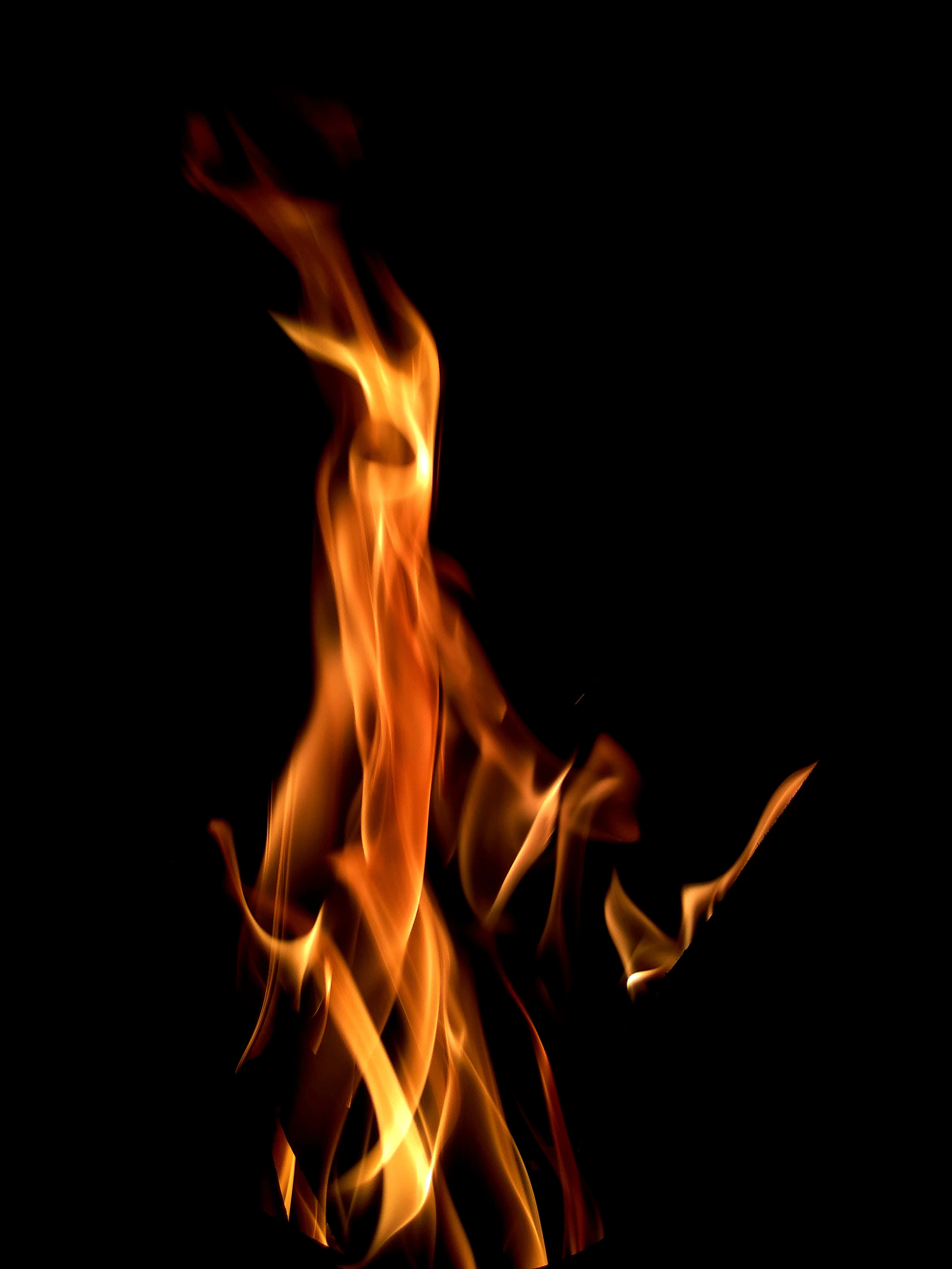 μια φλόγα φωτιάς σε μαύρο φόντο Ταπετσαρία